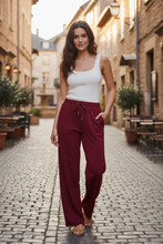 Load image into Gallery viewer, Burgundy Joggers on European Street
